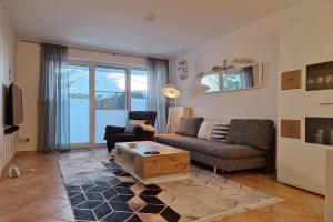 a living room with a couch and a coffee table at Ferienwohnung Graugans in Baabe