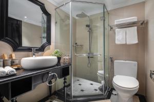 a bathroom with a toilet and a glass shower at Sapa Boutique Hotel & Spa in Sapa