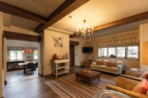 a living room with a couch and a table at Ormesby Manor House & The Shepherds Huts & Well Lodge in Ormesby Saint Michael