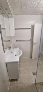 a white bathroom with a sink and a mirror at City Center House in Vodice +20 photos