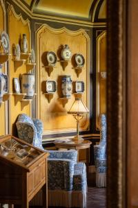a room with two chairs and a table with a lamp at Château de Courcelles - Relais & Châteaux in Courcelles-sur-Vesle