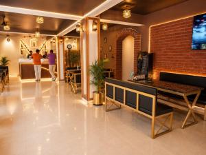 a lobby with a brick wall and people walking in it at Sanctuary Boutique Hotel in Bhīm Tāl