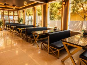 a row of tables and chairs in a restaurant at Sanctuary Boutique Hotel in Bhīm Tāl