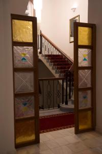two stained glass doors in front of a staircase at Vila Băncii 1888 by SunGarden in Băile Herculane