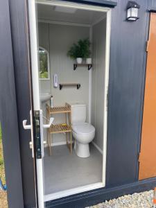 a small bathroom with a toilet and a sink at Zimnik Camp in Lipowa
