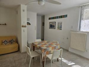a living room with a table and chairs and a couch at Casa de Diego in Francavilla al Mare