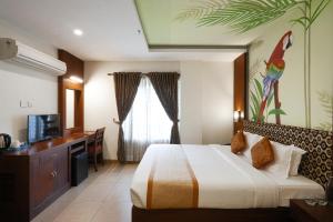 a hotel room with a bed and a television at Clay House in Trichūr +63 photos