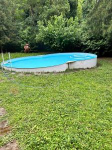 a blue boat sitting on the grass in a field at Villa Ca' dei Tigli in Porretta Terme