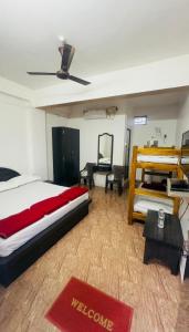 a bedroom with a bed and a desk in it at Hotel GANANJAYA in Gokarna +10 photos