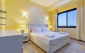 a bedroom with a white bed and a large window at Kika Des Hotel Suites - Serviced Apartments, Westland, Nairobi in Nairobi +89 photos