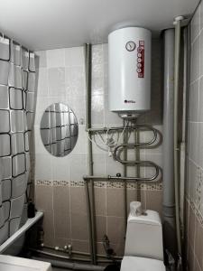 a bathroom with a shower and a toilet in it at Квартира 2 комнаты in Balqash