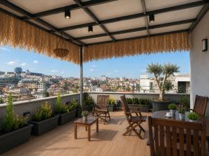a balcony with chairs and a view of a city at Endless Suites Taksim in Istanbul
