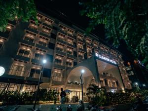 a person standing in front of a hotel at night at Clarion Hotel Hyderabad in Hyderabad