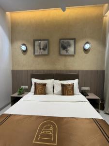 a bedroom with a large bed in a room at Hotel Unicorn Althan, Surat in Surat