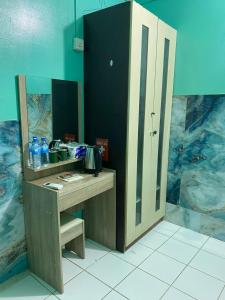 a desk with a mirror in a room at Wind Stay in Male City