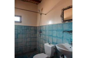 a bathroom with a toilet and a sink at Gite Tamlli in Aoufous +38 photos