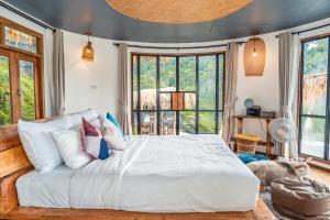 a bedroom with a large white bed and windows at Mountain Floating Cloud in Ban Kai Noi +99 photos