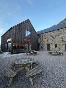 a group of picnic tables in front of a building at Ben Nevis Inn Rooms in Fort William