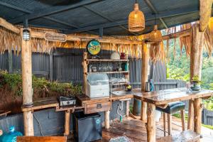 an outdoor kitchen with a table and a microwave at Mountain Floating Cloud in Ban Kai Noi