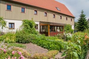 a large building with a garden in front of it at Reiter- und Ferienhof Wacker in Schöna