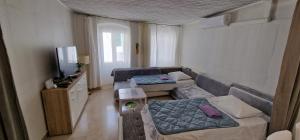 a small living room with a couch and a tv at City Center House in Vodice