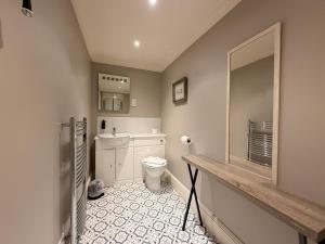a bathroom with a toilet and a sink at Loch Leven Hotel & Distillery in Glencoe +75 photos