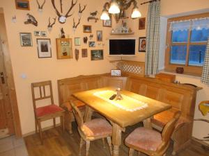 uma sala de jantar com uma mesa de madeira e cadeiras em Jägerhäusl em Arrach
