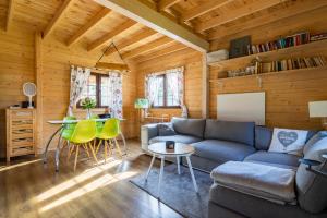 a living room with a couch and a table at Chrzanowa Dolina in Maruny