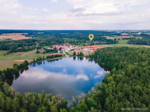 an aerial view of a lake with a hot air balloon at Chrzanowa Dolina in Maruny