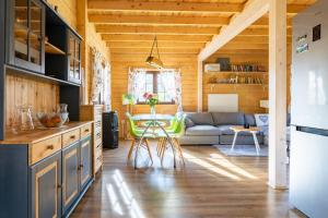 a kitchen and living room with a couch and a table at Chrzanowa Dolina in Maruny