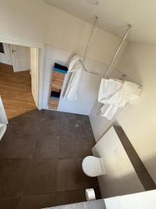 a bathroom with white towels hanging on a wall at Kaiserlich schlafen in der alten Post in Oelsnitz +18 photos