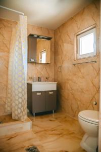 a bathroom with a toilet and a sink and a mirror at LUX apartman savić in Aleksinac +44 photos