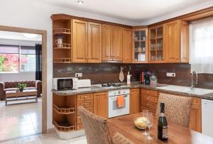 a kitchen with wooden cabinets and a wooden table at Casa Susana in Santa Eularia des Riu