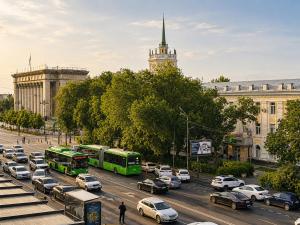 a busy city street filled with cars and buses at Nazarbayev avenue central studios in Almaty