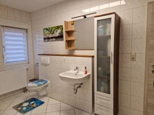 a bathroom with a sink and a toilet at Ferienwohnung Gretel in Görlitz