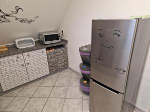 a kitchen with a refrigerator and a microwave at Ferienwohnung Gretel in Görlitz