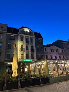 a building with a restaurant in front of it at Hotel Polonia in Ostrów Wielkopolski