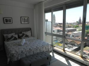 a bedroom with a bed and a large window at Bolhão Skyline in Porto