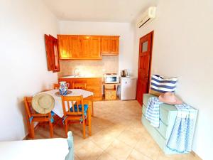a kitchen with a table and chairs in a room at Patmos Garden Sea in Grikos