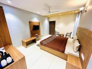 a hotel room with a bed and a television at La Casa Residency in Lucknow +20 photos