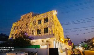 a tall building with lights on the side of it at La Casa Residency in Lucknow