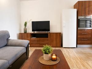 a living room with a couch and a refrigerator at Apartment Near Zadar Airport & City in Crno