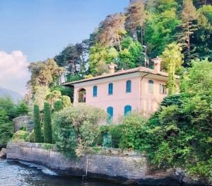 a house on a hill next to a river at Renzo in Bellagio