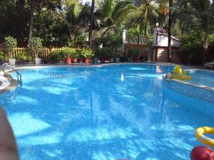 a large pool with blue water in a resort at Elegant Shades in Colva