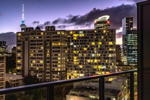 a view of a city skyline at night at Quest on Eden Auckland CBD Apartment Hotel in Auckland