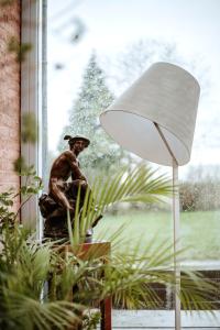 a statue of a man sitting in a window at Haras de Baudemont in Ittre
