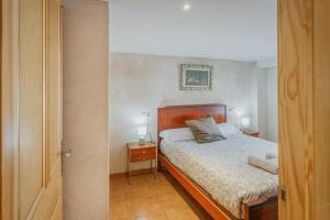a bedroom with a bed with two night stands and two lamps at Casa Romo 1 in Chavida