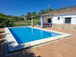 a swimming pool in front of a house at Huerta del Sol in Aracena