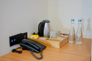 a desk with a phone and some bottles on it at Giri Rose Boutique Hotel in Kuta Lombok