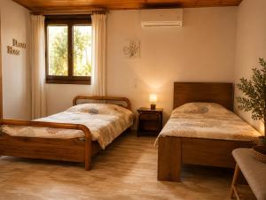 a bedroom with two beds and a window at Small Villa Gerani in Agios Vlasios